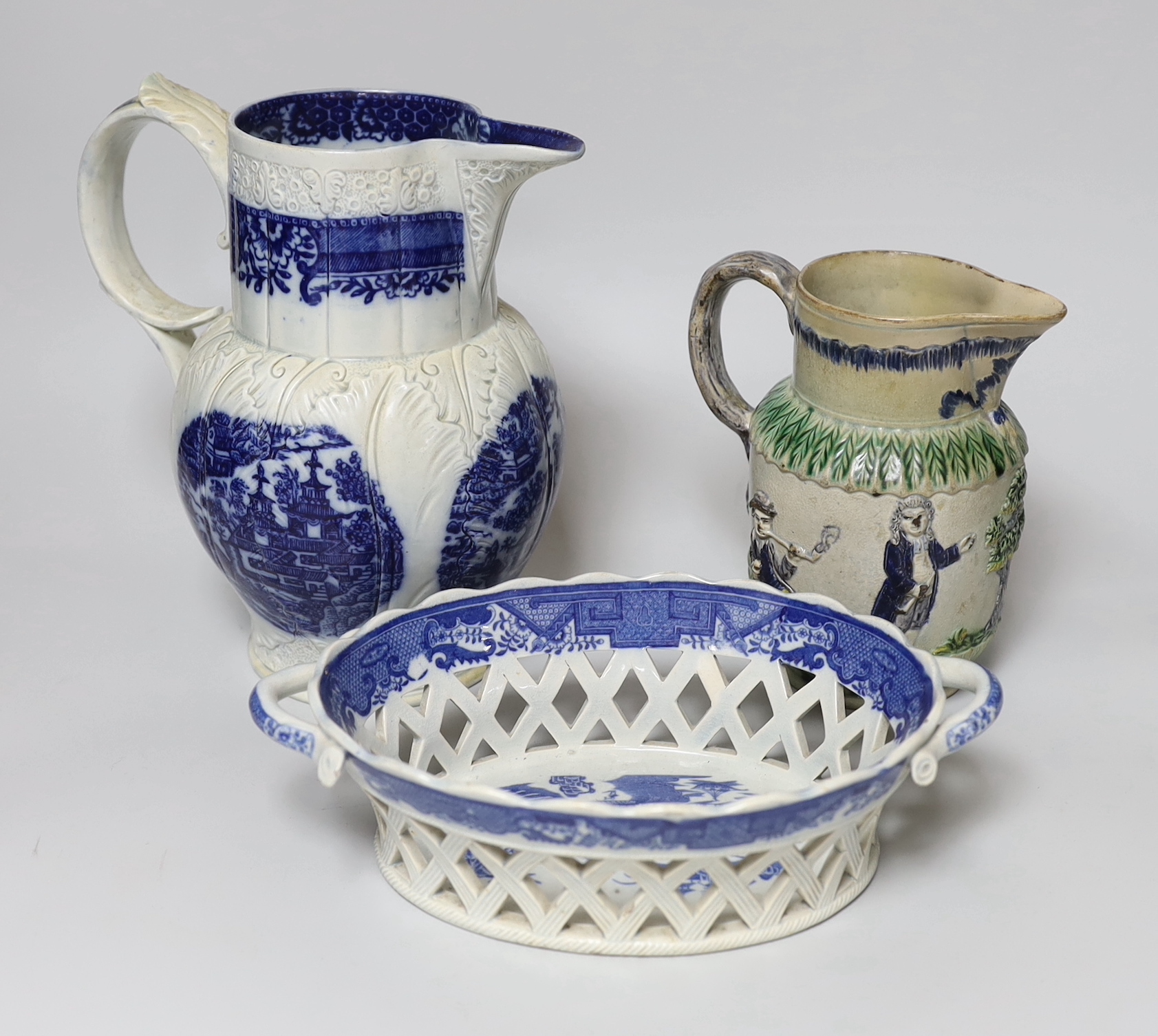 A late 18th century blue and white pearlware jug, a chestnut basket and a Pratt type jug (3), 21.5cm high